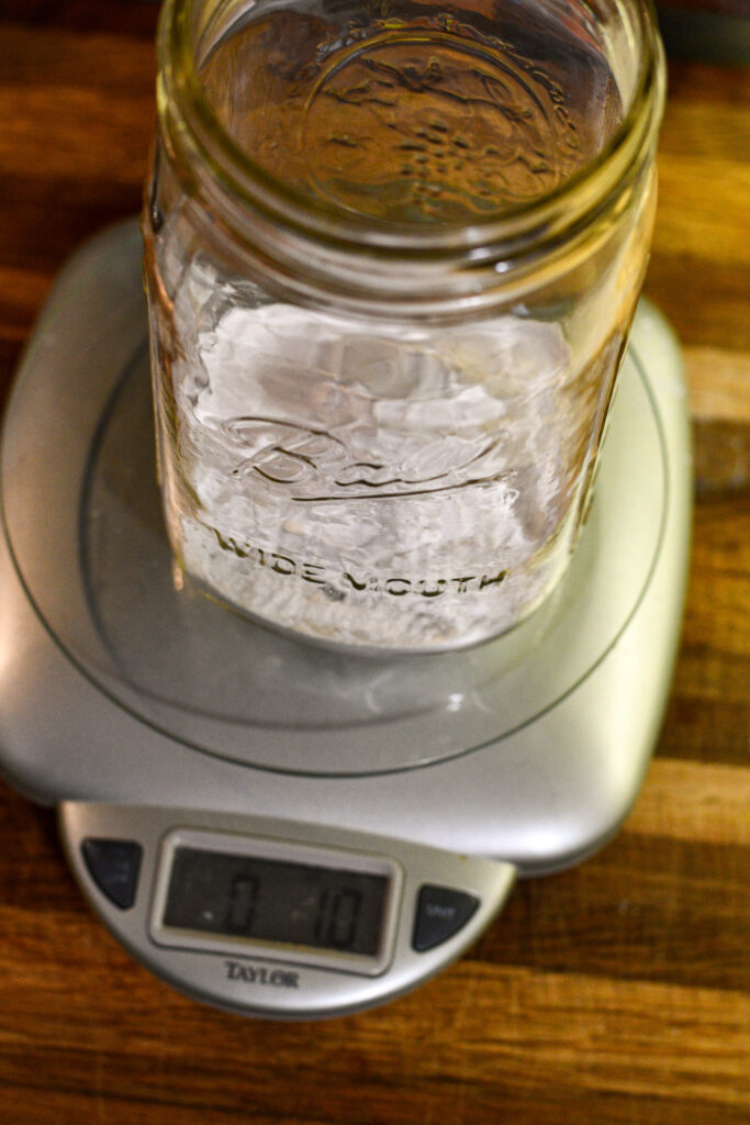 mason jar with lime inside sitting on a kitchen scale