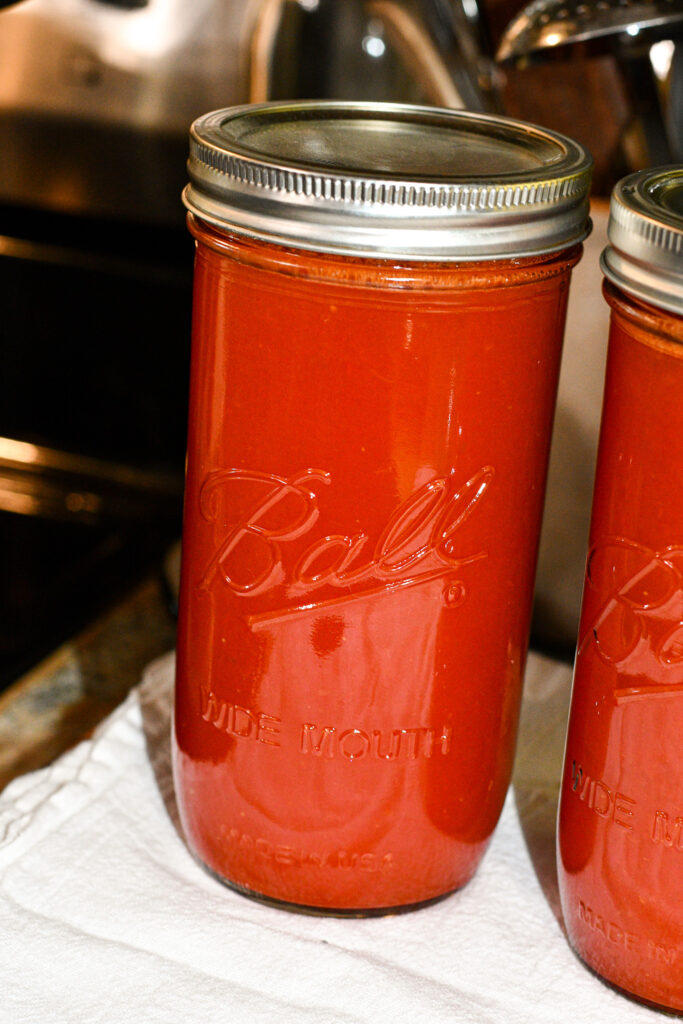 canned tomato juice sitting on a counter